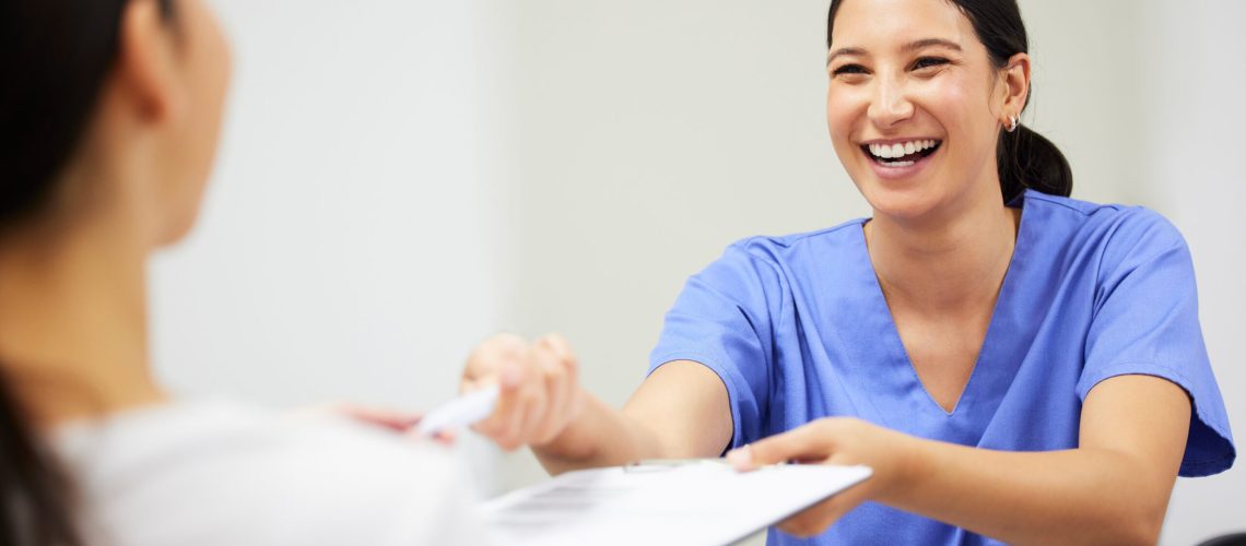Documents, happy and a nurse helping a patient in the hospital during an appointment or checkup. Insurance form, smile and a medical assistant at a health clinic to help with check in or sign up.