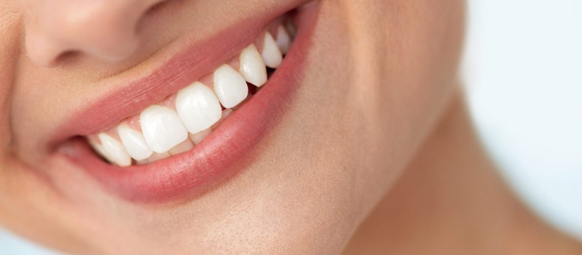 Closeup Of Beautiful Smile With White Teeth. Woman Mouth Smiling Beautiful Smile With White Teeth. Closeup Of Smiling Woman Mouth With Natural Plump Full Lips And Healthy Perfect Smile. Teeth Whitening, Dental Health And Lip Care Concepts. High Resolution Image