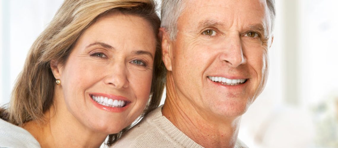Happy smiling elderly couple at new home